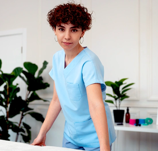 female student in medical uniform smiling