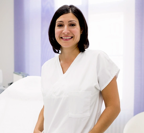 female student in medical uniform smiling